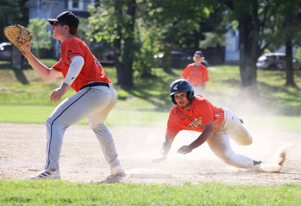 Stoughton runner Andrew Beder gets back to first base safely on a pick-off move as Oliver Ames' Jake Waxman prepares to make the tag during a game on Monday, May 16, 2022.