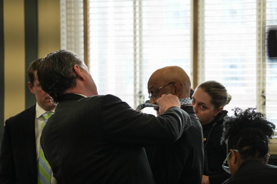 Cincinnati attorney Jay Clark helps former death-row inmate Elwood Jones put on a tie for a court hearing Tuesday. Hamilton County Judge Wende Cross granted Jones a new trial in the 1994 beating death of Rhoda Nathan, a New Jersey grandmother. Cross said prosecutors denied Jones a fair trial by withholding exculpatory evidence from his original defense team.