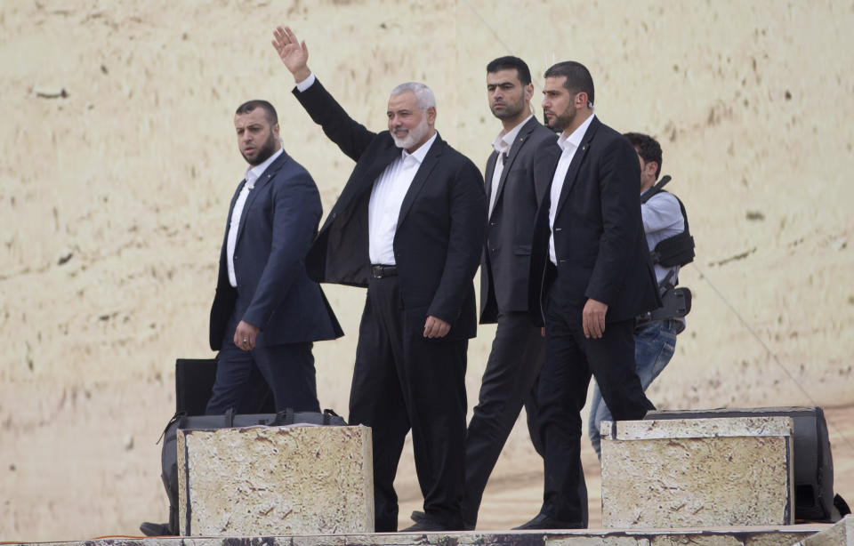 Hamas leader Ismail Haniyeh, greets supporters during a mass rally marking the 31st anniversary of the founding of Hamas, an Islamic political party, which has an armed wing of the same name, that currently rules in Gaza, Sunday, Dec. 16, 2018, in Gaza city. (AP Photo/Khalil Hamra)