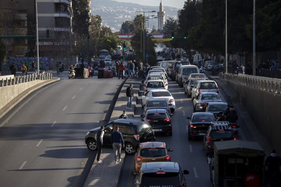 Cars are caught in a traffic jam as protesters block a main road that links the Lebanese capital Beirut to the southern suburbs, Wednesday, March 17, 2021. (AP Photo/Hassan Ammar)