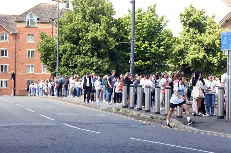 People queue for Taylor Swift merch on the Wood Street bridge in Cardiff