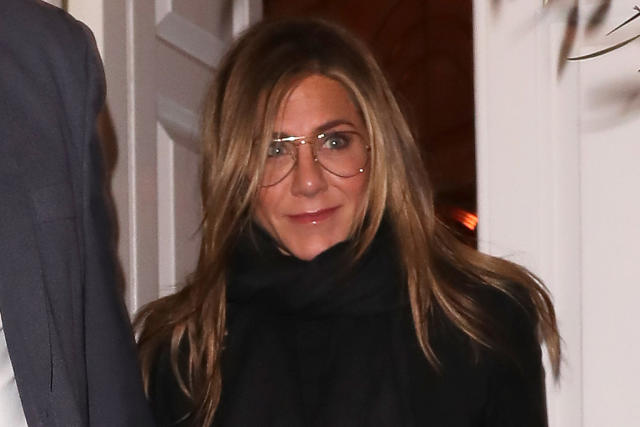 Jennifer Aniston in knit sweater, jeans, white sneakers and Louis