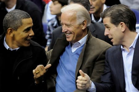 FILE PHOTO: U.S. President Obama, Vice President Biden and his son Hunter attend an NCAA basketball game between Georgetown University and Duke University in Washington