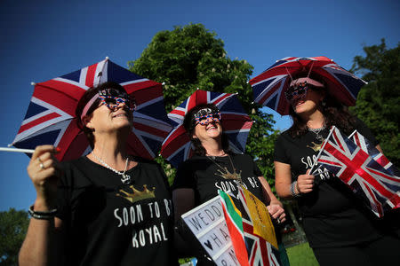 Royals fans, with Union Jack umbrella hats, look on ahead of Prince Harry and Meghan Markle's wedding in Windsor, Britain, May 19, 2018. REUTERS/Marko Djurica