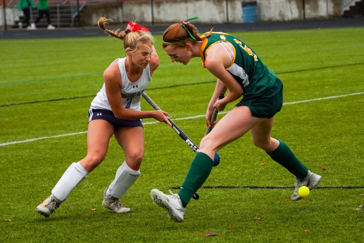 Mount Notre Dame defender Lucy Sander (white) pokes the ball away from Ursuline Academy forward Elise	Moeller (green) during the first half of the Southwest region final. Saturday, Oct. 28, 2023 at Fairmont High School.