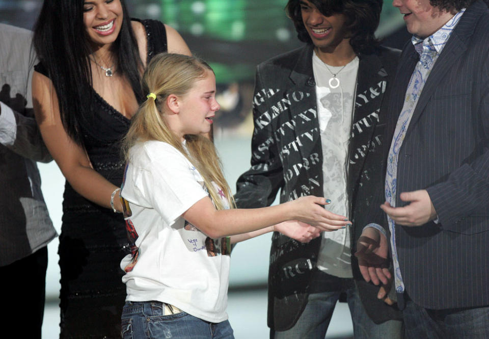 Ashley Ferl, 13 years old from Riverside, California, goes to hug contestant Chris Sligh onstage during the 6th season of American Idol.