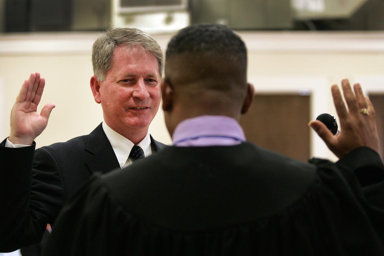 Craig Lowe is sworn in as mayor by county court Judge Walter Green, Thursday, May 20, 2010 at the Thelma Boltin Center in Gainesville, Fla.