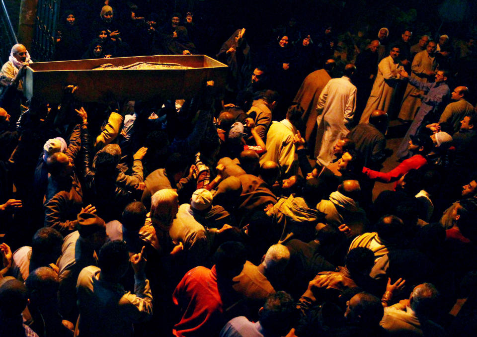 Relatives surround the coffin of 22 year-old journalist Mayada Ashraf, who was killed during clashes between Egyptian police and Muslim Brotherhood supporters, during her funeral in El-Monofiya, north of Cairo, Egypt, Saturday, March 29, 2014. Ashraf, who worked for the privately owned El-Dustour newspaper, was one of four people killed during clashes between security forces and hundreds of supporters of ousted Egyptian president Mohammed Morsi who took to the streets Friday to protest the decision by the country's former military chief to run in upcoming presidential elections. (AP Photo/Ahmed Gomaa)