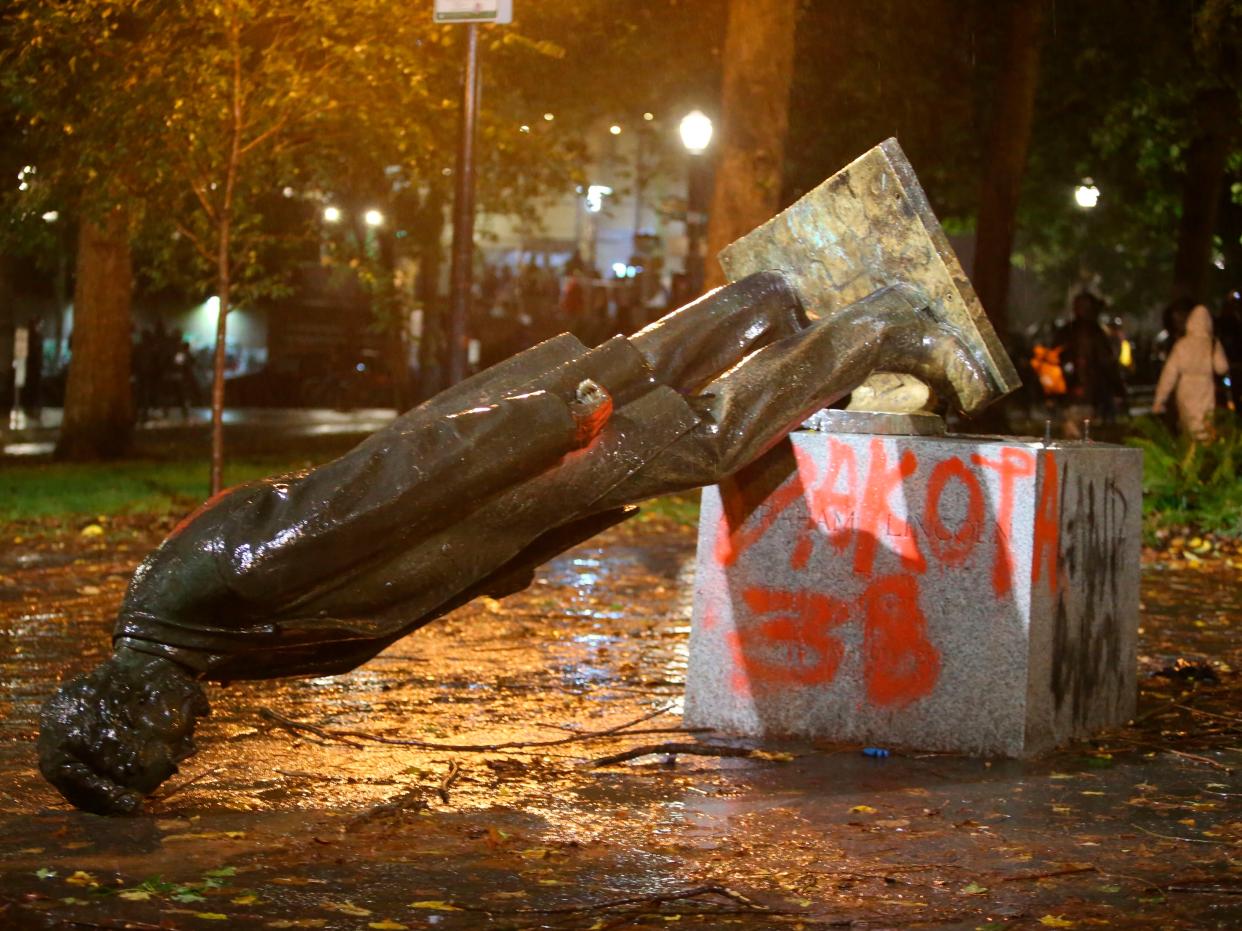 A group of protesters toppled statues of former presidents Theodore Roosevelt and Abraham Lincoln in Portland’s South Park Block late Sunday, 11 October, 2020 ((The Associated Press))