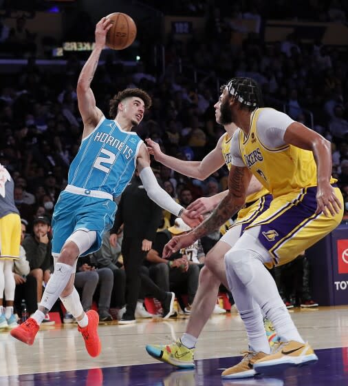 Los Angeles, CA, Monday, November 8, 2021 - Charlotte Hornets guard LaMelo Ball (2) twists his body to pass.
