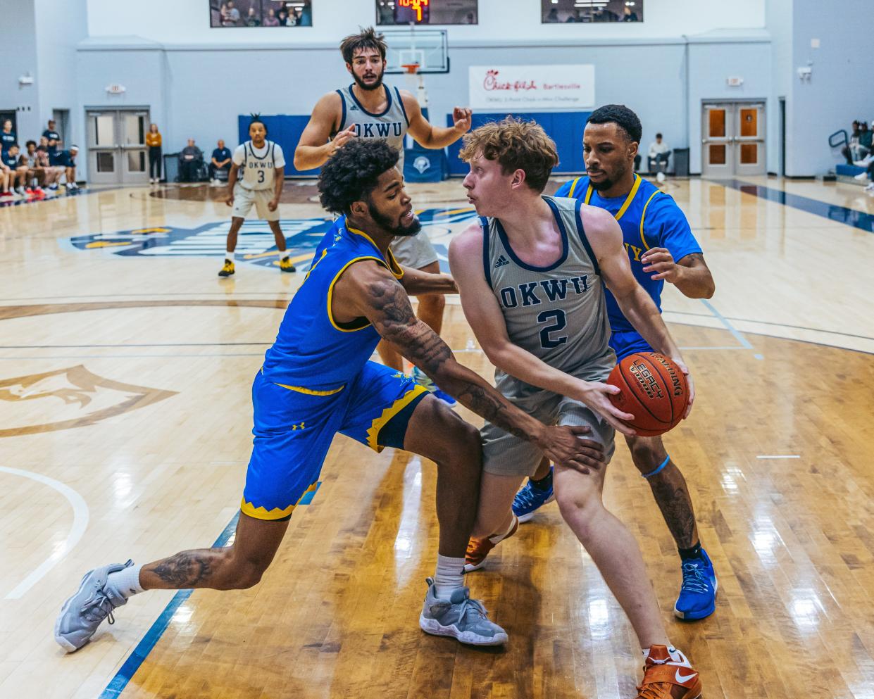 Oklahoma Wesleyan's Brandon Bird fights off the double team during a game in Nov. 2022 against Bethany.