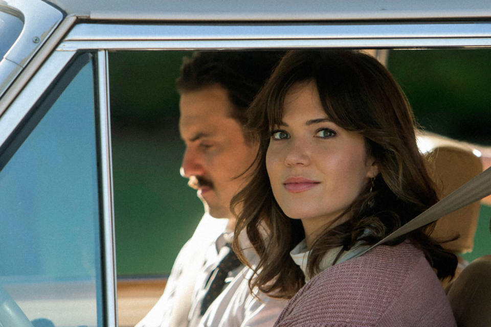 Mandy sitting passenger in an old car in a scene