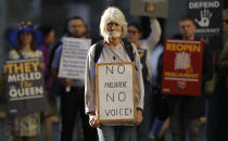 Protesters hold banners outside the Supreme Court in London, Tuesday Sept. 17, 2019. The Supreme Court is set to decide whether Prime Minister Boris Johnson broke the law when he suspended Parliament on Sept. 9, sending lawmakers home until Oct. 14 — just over two weeks before the U.K. is due to leave the European Union. (AP Photo/Matt Dunham)