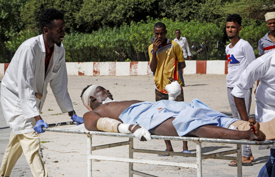 Medical workers help a man who was wounded in a bomb attack, at a hospital in the capital Mogadishu, Somalia Saturday, June 15, 2019. (AP Photo/Farah Abdi Warsameh)