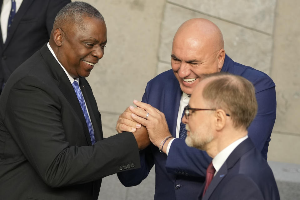 United States Secretary of Defense Lloyd Austin, left, shakes hands with Italy's Defense Minister Guido Crosetto during a group photo during a meeting of the North Atlantic Council in defense ministers format at NATO headquarters in Brussels, Thursday, Oct. 12, 2023. (AP Photo/Virginia Mayo)