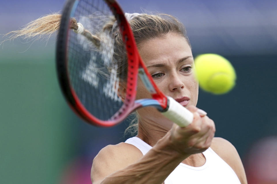 Italy's Camila Giorgi in action against Shelby Rogers during day five of the Viking International tennis tournament at Devonshire Park, Eastbourne, England, Wednesday June 23, 2021. (Gareth Fuller/PA via AP)