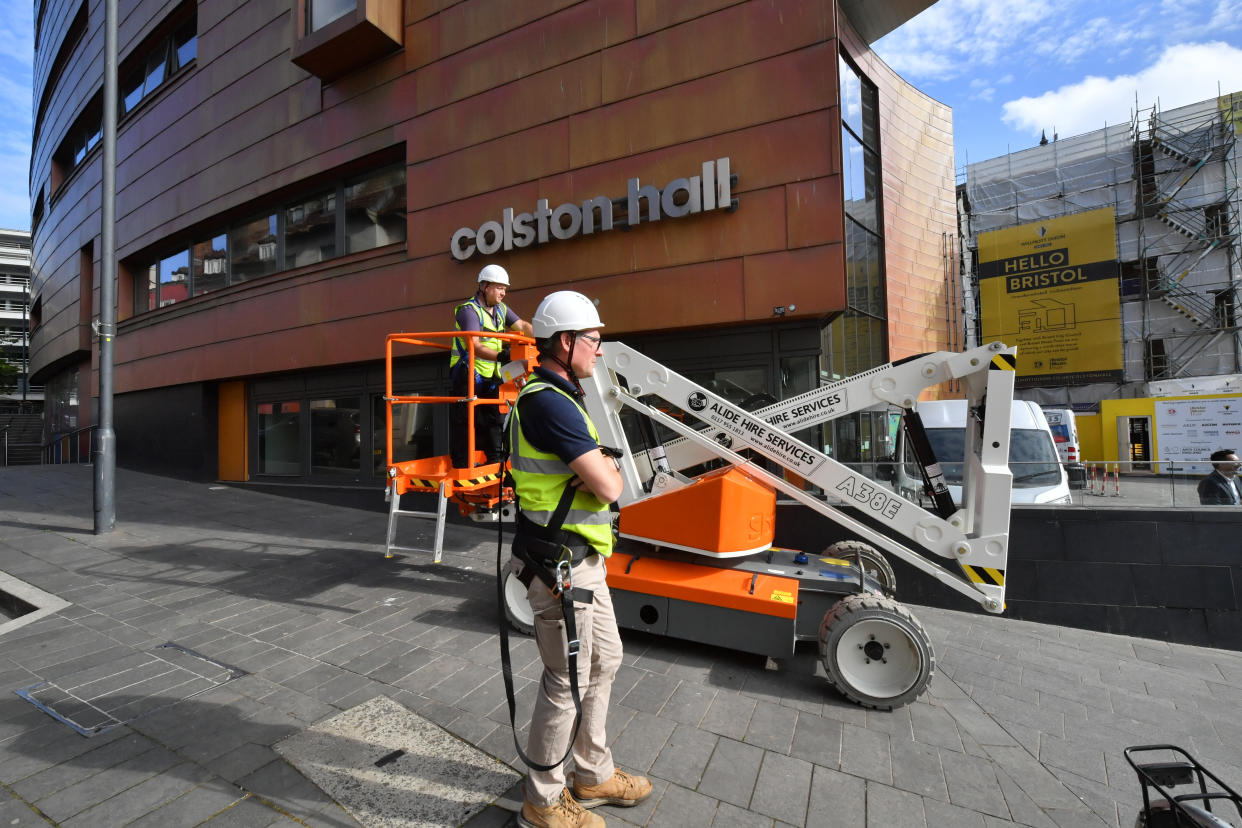 Contractors outside Bristol music venue Colston Hall for the removal of the name of 17th century merchant Edward Colston from its signage after a row over his involvement in the slave trade. The venue said the move was "just one step on our road to announcing a new name for the venue in autumn 2020".