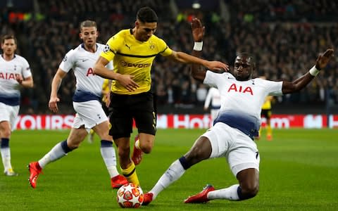 Moussa Sissoko, right, tackles Dortmund defender Achraf Hakim - Credit: AP Photo/Alastair Grant