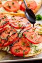 <p>This recipe is even wonderful when tomatoes aren't in season. In the oven, sad-looking slices take on a deeper, sweeter, more tomato-y flavour. If you don't want to make your own balsamic glaze, you can find it bottled at most grocery stores.</p><p>Get the <a href="https://www.delish.com/uk/cooking/recipes/a33070947/caprese-garlic-bread-recipe/" rel="nofollow noopener" target="_blank" data-ylk="slk:Caprese Garlic Bread;elm:context_link;itc:0;sec:content-canvas" class="link ">Caprese Garlic Bread</a> recipe.</p>