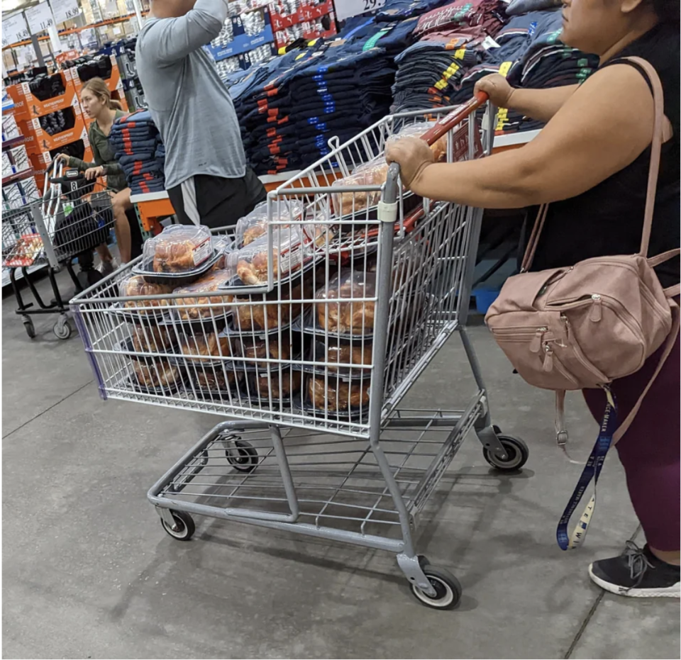 A grocery basket filled with rotisserie chickens