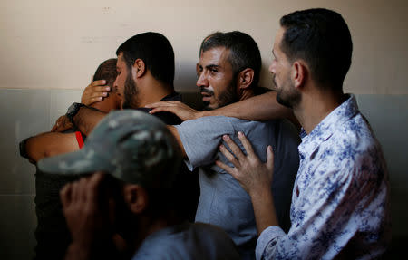 Relatives of a Palestinian, who was killed in an Israeli air strike, react at a hospital in the northern Gaza Strip October 17, 2018. REUTERS/Mohammed Salem