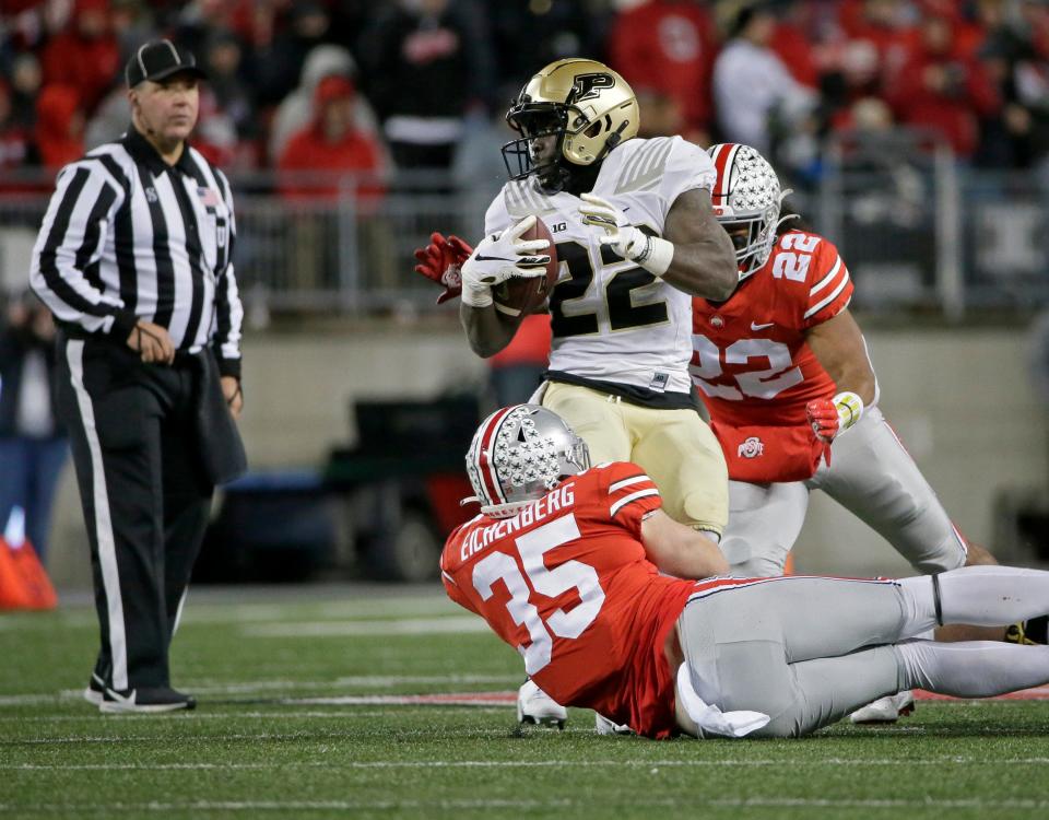 Purdue Boilermakers running back King Doerue (22) is tackled by Ohio State Buckeyes linebacker Tommy Eichenberg (35) and Ohio State Buckeyes linebacker Steele Chambers (22) during the fourth quarter of Saturday's NCAA Division I football game at Ohio Stadium in Columbus, Oh., on November 13, 2021.
