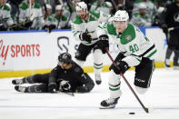 Dallas Stars center Jacob Peterson (40) breaks out after Tampa Bay Lightning right wing Mathieu Joseph (7) during the third period of an NHL hockey game Saturday, Jan. 15, 2022, in Tampa, Fla. (AP Photo/Chris O'Meara)