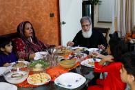 Ali Hasan Baqai, whose family was divided by the partition of the subcontinent in 1947, sits along with his wife Shaistan Ali and grand children to have lunch, at his home in Karachi