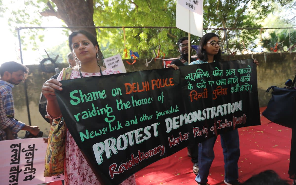 Student activists and activists of various left organisations hold placards and shout slogans during a protest against the arrest of NewsClick journalists in Delhi (EPA)