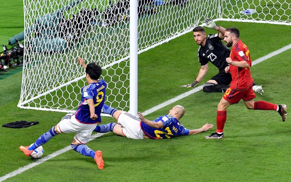 Japan's Kaoru Mitoma crosses the ball as the ball appears to cross the line - Jennifer Lorenzini /Reuters