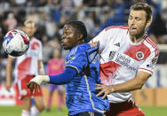 CF Montreal's Kwadwo Opoku, left, keeps his eyes on the ball as New England Revolution's Dave Romney defends during the second half of an MLS soccer match Saturday, Aug. 26, 2023, in Montreal. (Graham Hughes/The Canadian Press via AP)