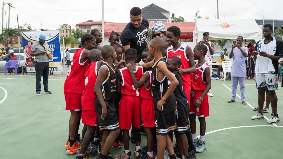 Giannis Antetokounmpo visits with children during his trip to Nigeria. The August 2023 trip is documented in the film, "Ugo: A Homecoming Story," available to watch for free on YouTube.