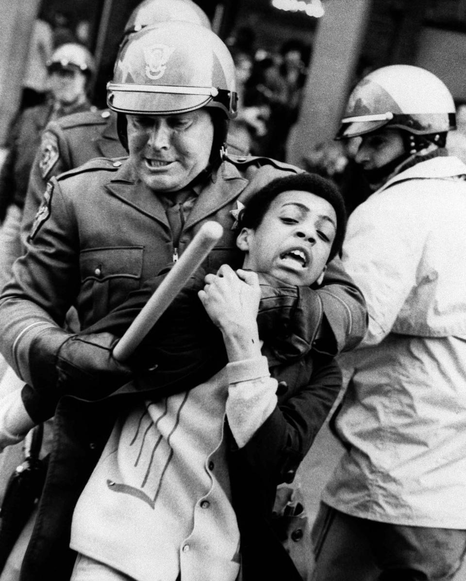 A pursuing police officer holds a youthful demonstrator during a skirmish on the University of California campus in Berkeley on Feb. 19, 1969. Police arrested 25 persons, most on charges of disorderly conduct and resisting arrest, including a 13-year-old.