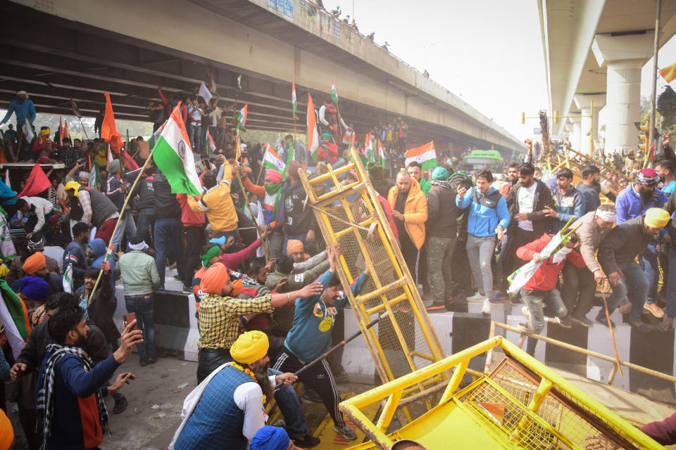 Protesters remove police barricades from the road during the...