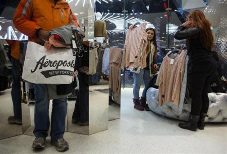 People shop at H&M on Thanksgiving Day in New York November 28, 2013. While most in the United States spent the day bonding with friends and family over turkey dinners and football games, some were enticed by big discounts and open stores to begin their holiday bargain-hunting a day earlier than the traditional "Black Friday" sprees that follow Thanksgiving. REUTERS/Eric Thayer