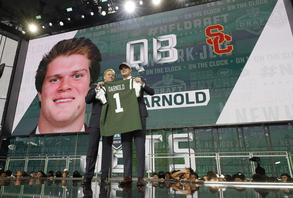 FILE - Commissioner Roger Goodell, left, poses with USC's Sam Darnold after being picked by the New York Jets during the first round of the NFL football draft, Thursday, April 26, 2018, in Arlington, Texas. Whether it's the Jets giving away three extra second-round picks to move up and take San Darnold third overall in 2018 or the 49ers giving up three first-round picks to draft Trey Lance third overall in 2021 only to have him start four games his first two seasons, there have been many misses. (AP Photo/David J. Phillip, File)