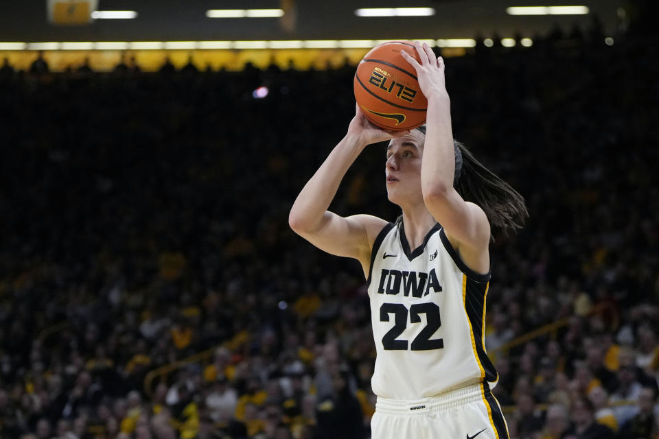 Iowa guard Caitlin Clark (22) shoots a 3-pointer against Michigan during the second half of an NCAA college basketball game Thursday, Feb. 15, 2024, in Iowa City, Iowa. (AP Photo/Matthew Putney)