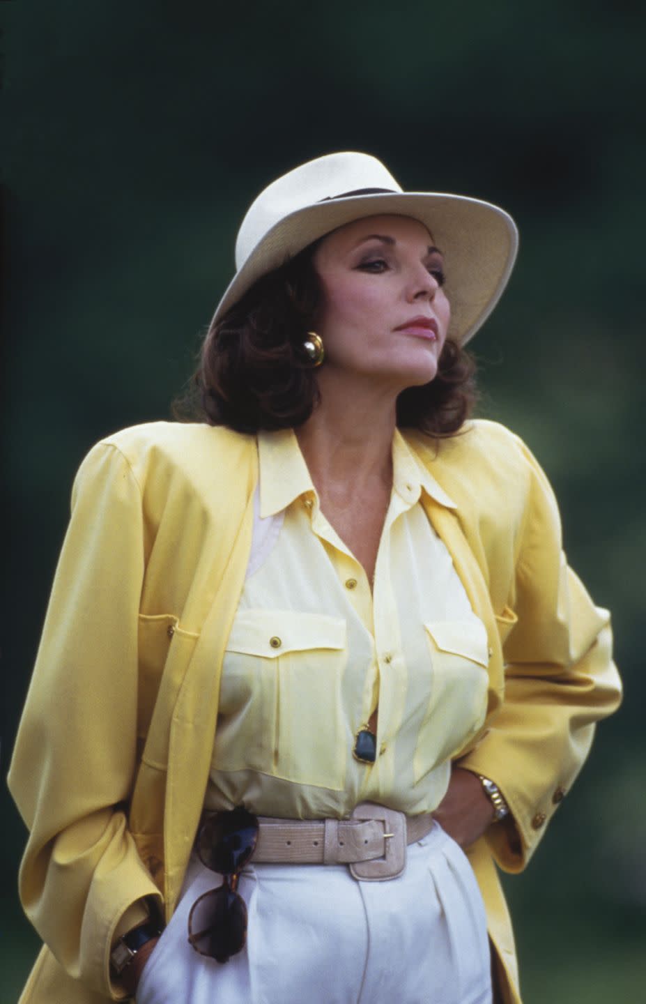 <p>Joan Collins looked like a springtime dream at this English golf tournament. The bright yellow look really came together with her neutral accessories.</p>