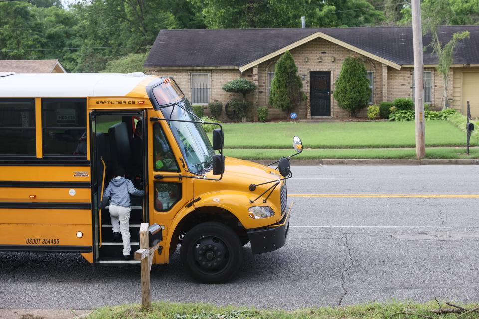 Kevin Bardwell Jr. boards the bus for his last day of school outside the family's Frayser home on Friday, May 27, 2022.