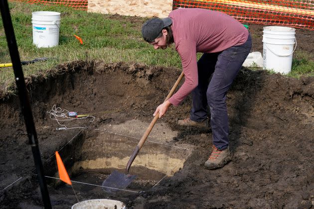 Archeological technician Makenzie Coufal clears soil away as workers dig for the suspected remains of children who once attended the Genoa Indian Industrial School, on Tuesday, July 11, 2023, in Genoa, Neb. 