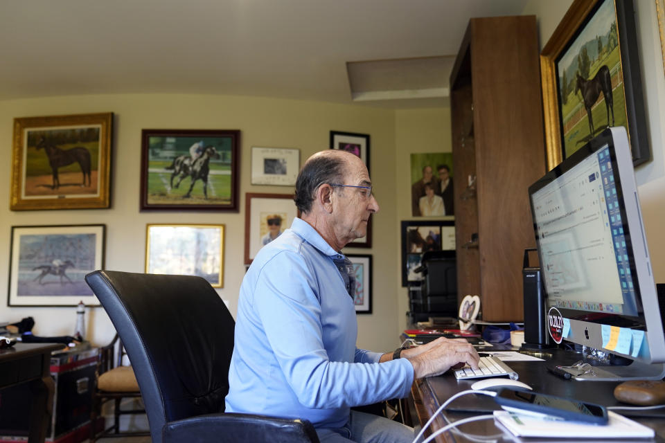 Richard Shapiro poses for a photo at his home, Thursday, April 29, 2021, in Hidden Hills, Calif. Shapiro was one of the victims of the Bernard Madoff Ponzi scheme. When the scam was revealed in 2008, Shapiro had retired. He went back to work and managed to save his home. His marriage ended about two years later and he believes the stress over the Madoff debacle contributed to its end. (AP Photo/Marcio Jose Sanchez)