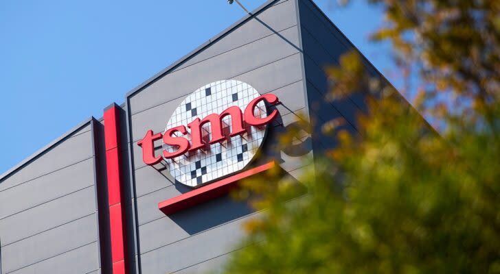 An image of a grey TSMC corporation building with the "tsmc" logo in red.