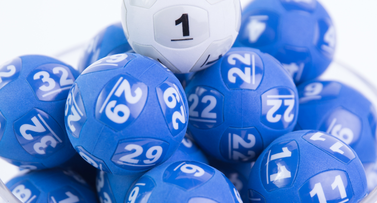 Blue and white Powerballs are seen stacked in a pile ahead of tonight's $100 million draw. 