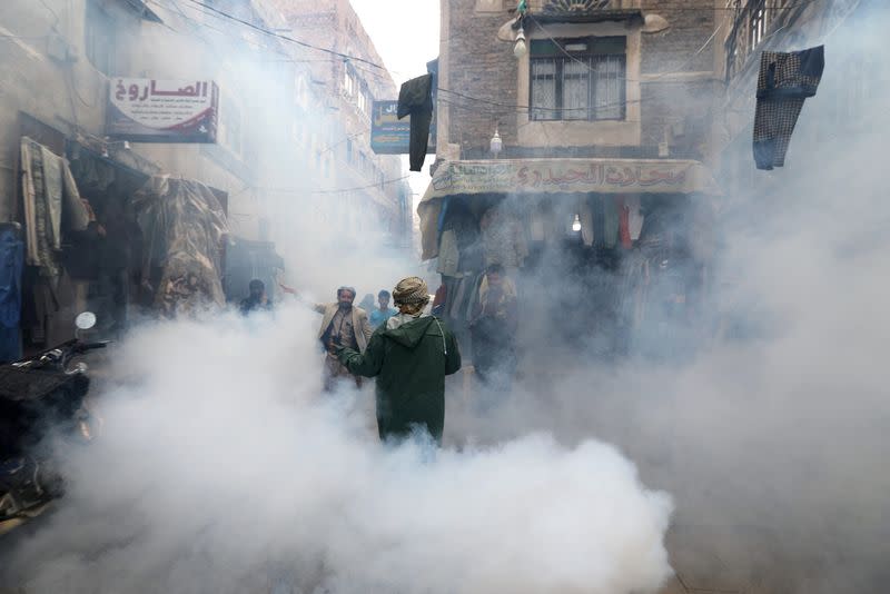 FILE PHOTO: Health workers fumigate a market amid concerns of the spread of the coronavirus disease (COVID-19), in Sanaa