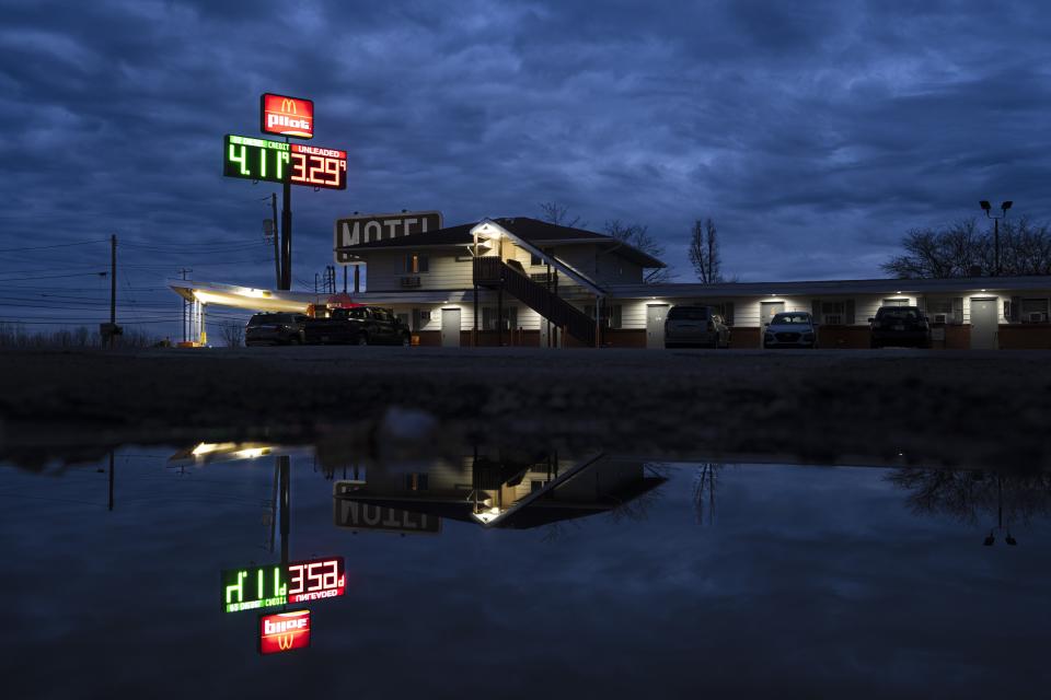 Lights are reflected from the Davis Motel, where several people displaced by the East Palestine train derailment are living, in North Lima, Ohio, Monday, April 3, 2023. Norfolk Southern Railroad is paying for lodging for some families but won't say how many still are out of their homes while the railroad excavates tens of thousands of tons of contaminated soil, a process the Environmental Protection Agency expects to take another 2-3 months. (AP Photo/Matt Rourke)