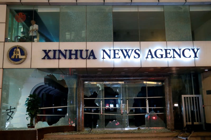 Damaged entrance of China's official Xinhua news agency is seen during anti-government protest in Hong Kong