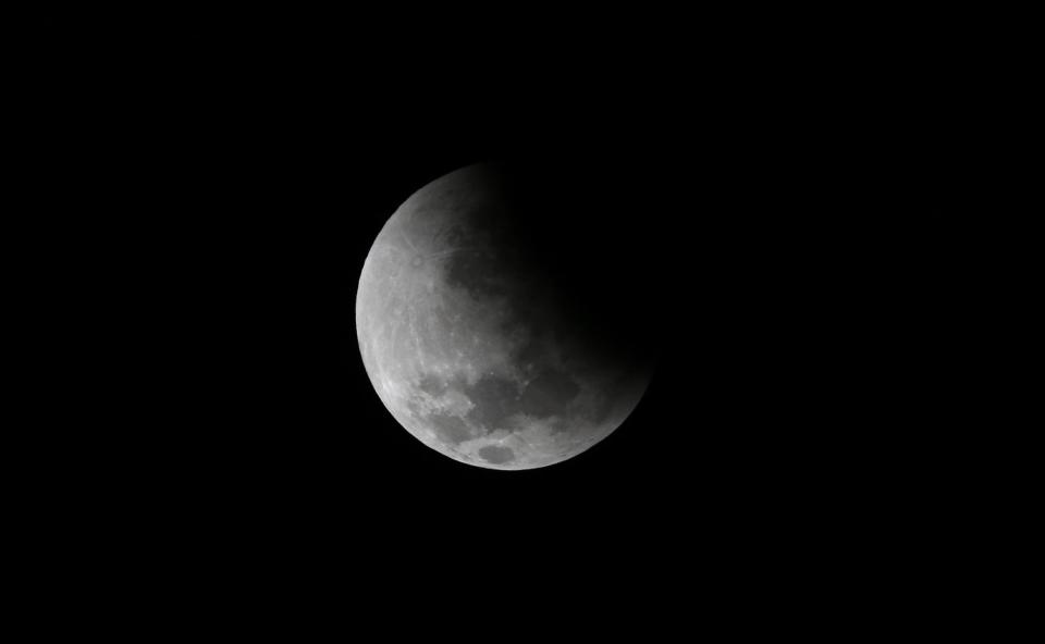 The moon is seen as it begins a total lunar eclipse that will turn the moon red over Buenos Aires April 15, 2014. (REUTERS/Marcos Brindicci)