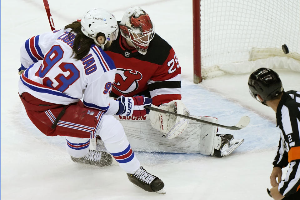 New York Rangers center Mika Zibanejad (93) scores behind New Jersey Devils goaltender Mackenzie Blackwood (29) as an official looks into the net during the first period of an NHL hockey game, Tuesday, April 13, 2021, in Newark, N.J. (AP Photo/Kathy Willens)