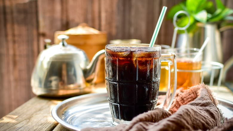 oliang thai-style coffee in glass cup with plastic straw