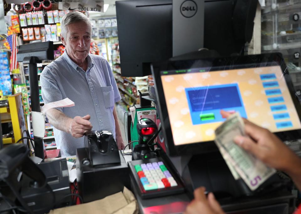 David Knight buys Powerball tickets at the Shell Gateway store on March 26, 2019 in Boynton Beach, Florida.